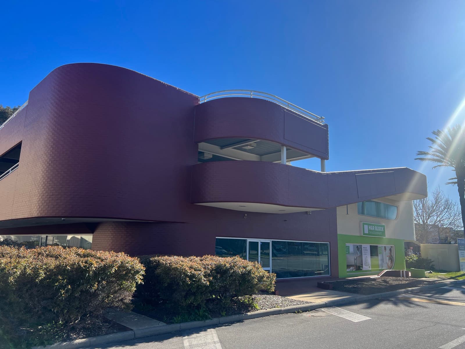 Commercial facade repainted in maroon and white by Super Painting WA