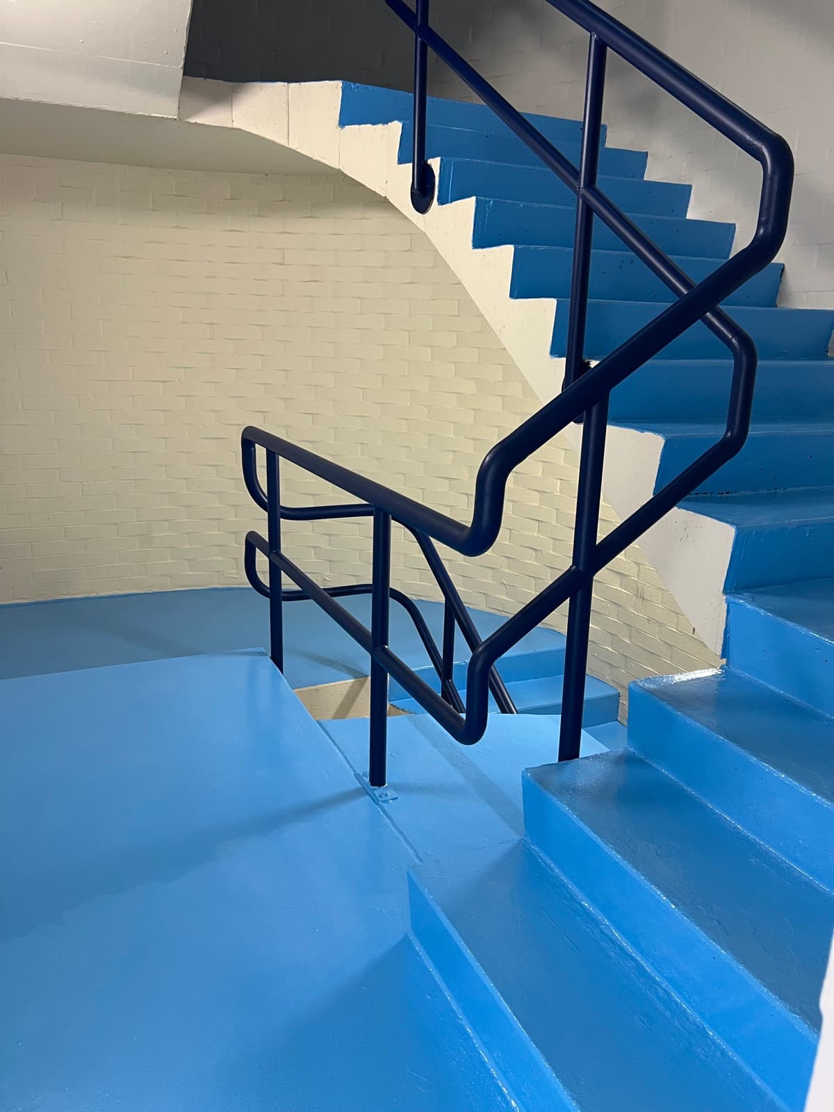 Stairwell repainted blue with navy handrails by Super Painting WA