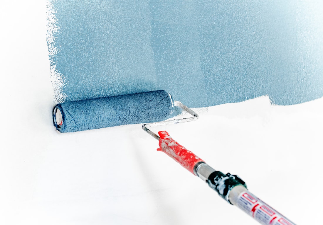 Professional painter applying a flawless interior wall finish in a Perth home