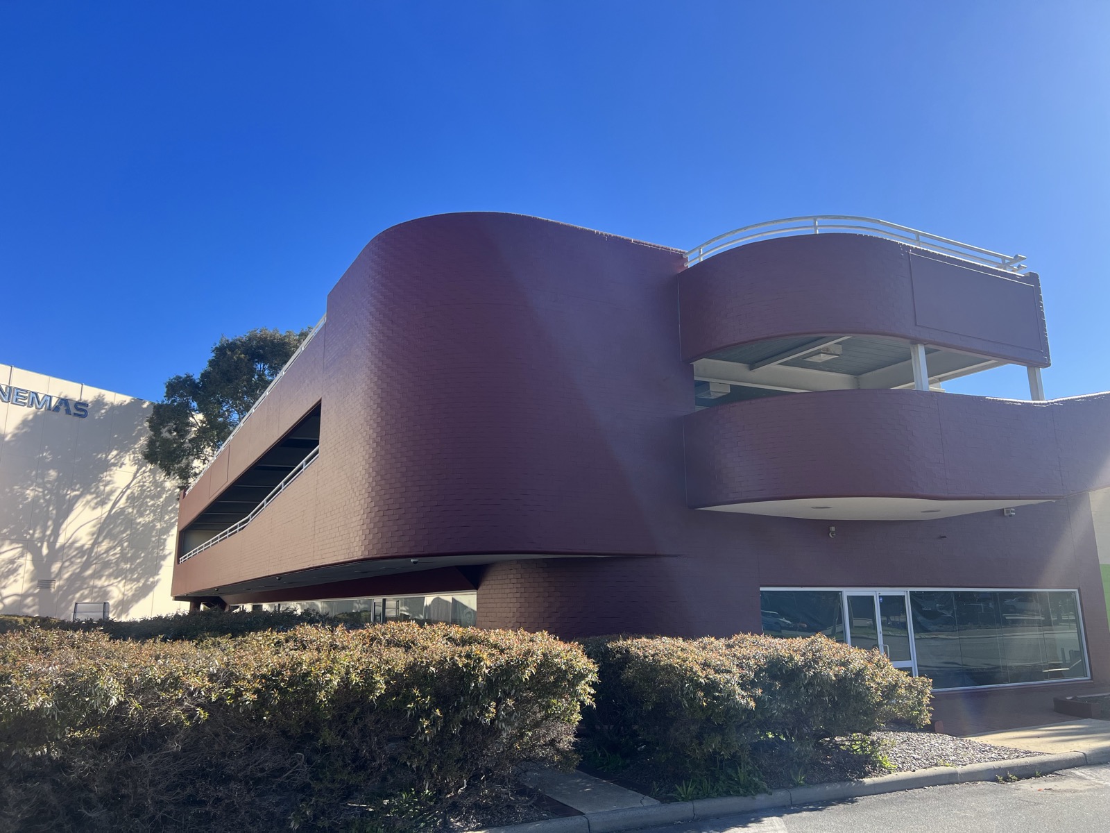 Commercial exterior repaint of a curved brick facade in Perth